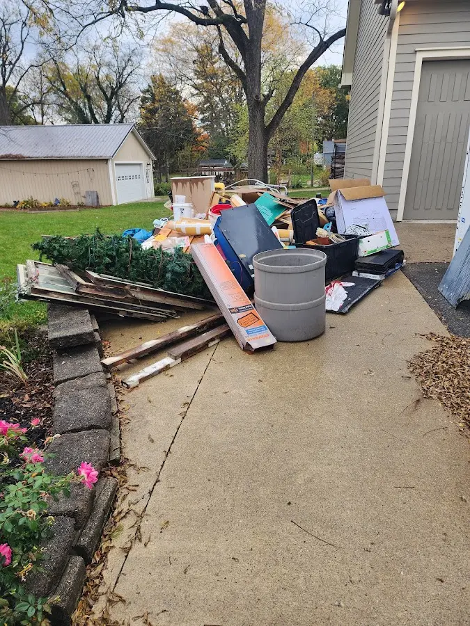 Dumpster being loaded with debris for Estate Cleanout Dumpster Rental in Jackson